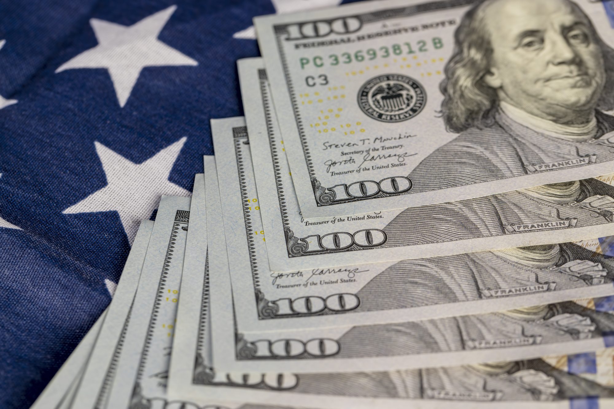American dollars and the American flag, part of the American flag with stars and red and white stripes and American currency dollars