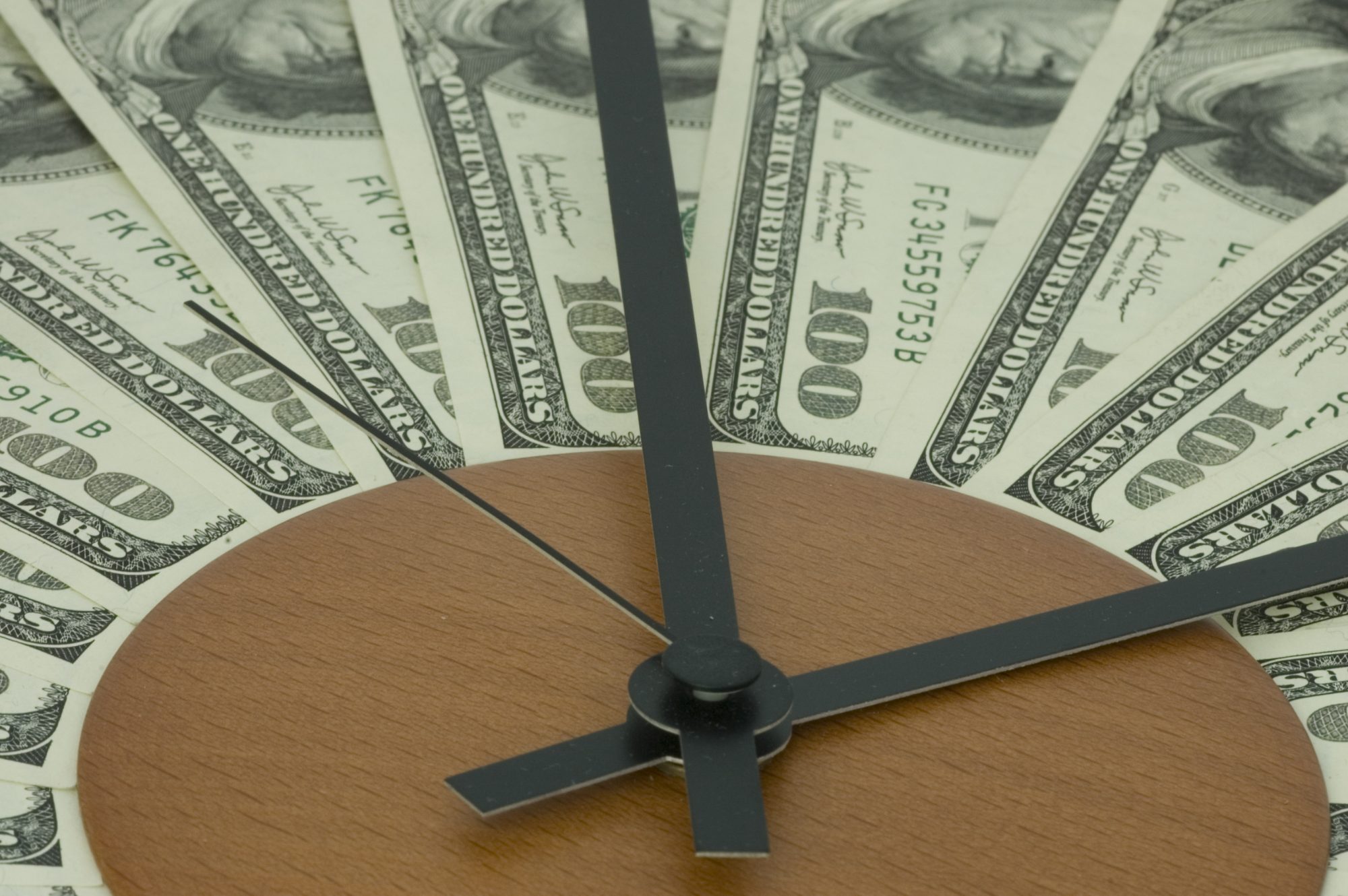 Banknotes lying on a dial and symbolising time 
spent nothing.
